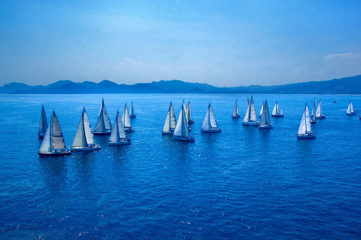 Sailing regatta boats in Mediterranean sea with mountains
