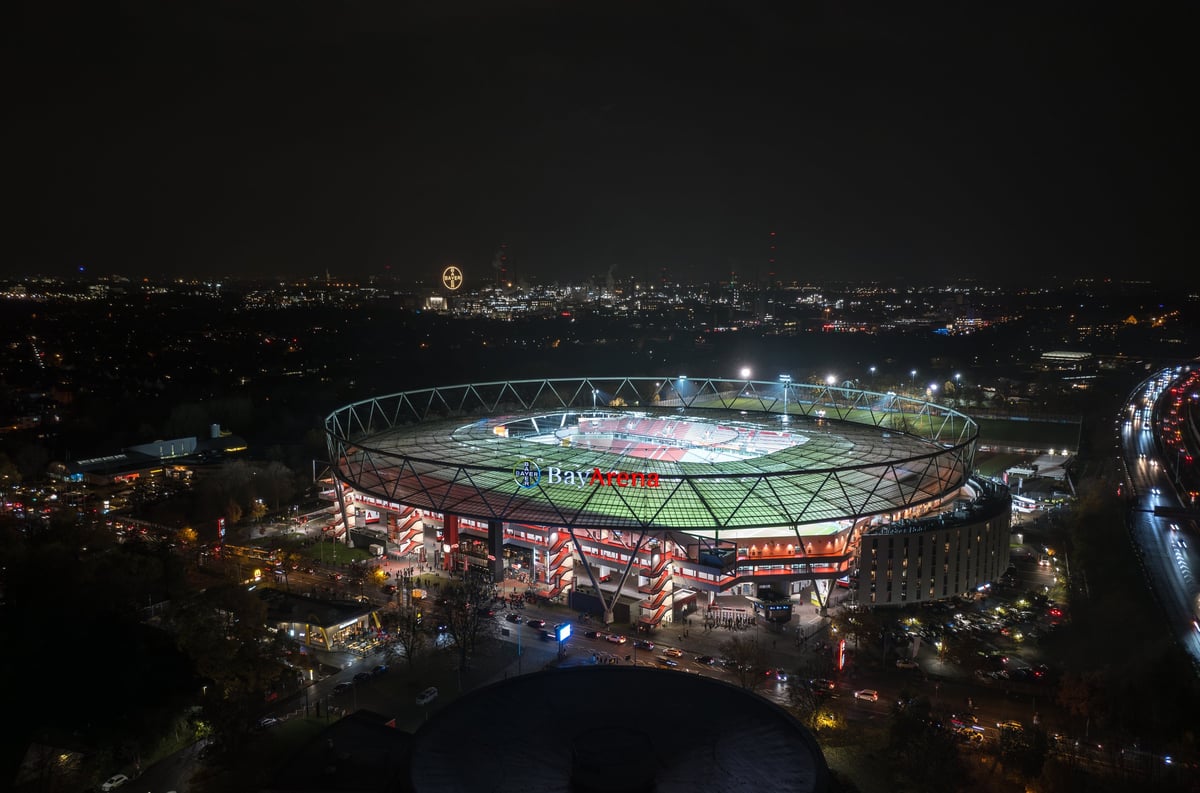 Leverkusen, North Rhine-Westphalia, Germany - November, 2023: Aerial night panorama view of the illuminated BayArena, home stadium of Bundesliga football club Bayer 04