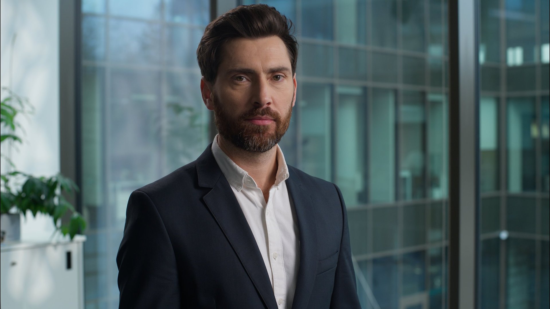 Caucasian man portrait businessman business bearded handsome male turning head looking at camera guy smiling positive leader professional manager employer boss CEO office indoor happy worker executive
