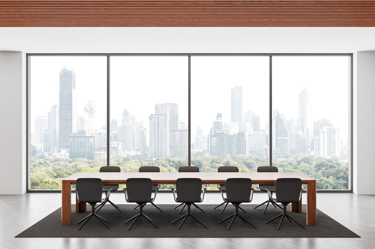 Stylish modern conference room with sleek furniture, wooden ceiling and panoramic city view through large glass windows